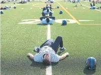  ?? RENÉ JOHNSTON/TORONTO STAR ?? Toronto Argo players and hopefuls work out on Thursday at the team’s training camp held at York University.