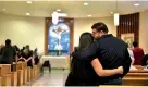  ??  ?? Friends and family gather for a mass in honour of victims who died in a mass shooting at a Walmart store in El Paso, Texas. Reuters