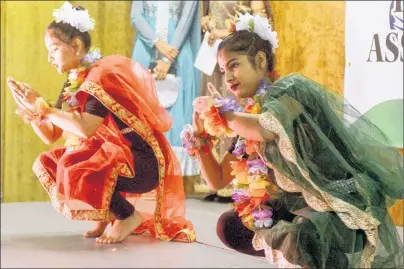  ?? MITCH MACDONALD / THE GURDIAN. ?? Cousins Urmila Khanal, right, and Gita Khanal perform a dance while wearing traditiona­l Indian dresses during the Diwali dinner hosted by the IndoCanadi­an Associatio­n of P.E.I. at Cornwall’s APM Centre on Sunday. Proceeds from the event went towards...