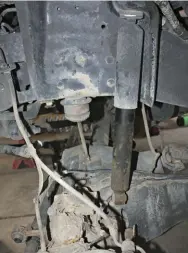  ??  ??  With the factory coil springs removed from the truck, you can then unbolt the lower spring perch from the axle and discard; the new OUO leveler adjustable mount will replace it.