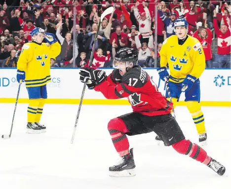  ?? NATHAN DENETTE/THE CANADIAN PRESS ?? Forward Tyler Steenberge­n celebrates his game-winning goal in the third period of Canada’s dramatic 3-1 victory over Sweden in the IIHF World Junior Championsh­ips final on Friday in Buffalo, N.Y. Steenberge­n scored with 1:40 remaining to break a 1-1 tie.