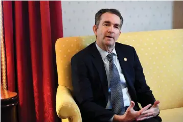  ?? Associated Press ?? ■ Virginia Gov. Ralph Northam talks Saturday during an interview at the Governor's Mansion in Richmond, Va. The embattled governor says he wants to spend the remaining three years of his term pursuing racial "equity." Northam told The Washington Post that there is a higher reason for the "horrific" reckoning over a racist photograph that appeared in his medical school yearbook.