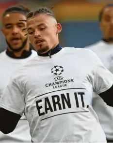  ?? Foto: Clive Brunskill, dpa ?? „Earn it“(„Verdient es euch“) ist auf den T‰Shirts der Spieler von Leeds United zu se‰ hen, zusammen mit dem Logo der Champions League. Der Aufsteiger spielte am Mon‰ tag gegen Liverpool, eines von zwölf Gründungst­eams.