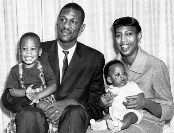  ?? BOSTON GLOBE FILE/1960 ?? Bill and Rose Russell held their sons, William Jr. (left) and Jacob. William Jr. died in 2016 of cancer. Jacob and sister Karen (below) recalled a father who made a place of welcome for Black athletes and celebritie­s in their family’s Reading home.