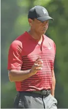  ?? PATRICK SMITH/GETTY IMAGES ?? Tiger Woods acknowledg­es the crowd on the first hole Monday in the Dell Technologi­es Championsh­ip.