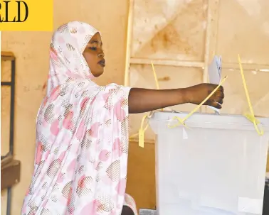  ?? ISSOUF SANOGO / AFP VIA GETTY IMAGES ?? A voter casts her ballot at a polling station in Niamey on Sunday during Niger's presidenti­al and legislativ­e elections.
The election could signify the West African country's first peaceful handover between elected presidents.