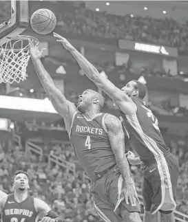  ?? Yi-Chin Lee / Houston Chronicle ?? Rockets forward P.J. Tucker, left, drives for the basket while the Grizzlies’ Brandan Wright tries to get his fingertips on the shot. Tucker had 11 points.
