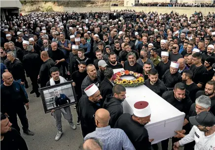  ?? AP ?? Members of the Israeli Druze Arab minority carry the body of Tiran Fero, 17, during his funeral in Daliyat al-Carmel, Israel.
