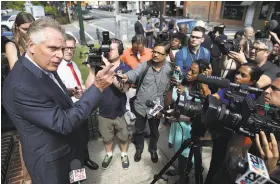  ?? Win McNamee / Getty Images ?? Virginia Gov. Terry McAuliffe tells reporters that police acted responsibl­y during the violent white nationalis­t rally in Charlottes­ville on Saturday night.