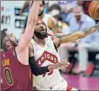  ?? Tony Dejak / Associated Press ?? Toronto’s Deandre’ Bembry drives to the basket against Cleveland’s Kevin Love in their game Saturday.