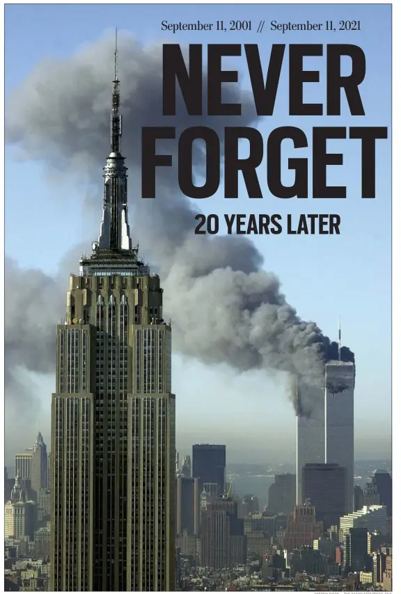  ?? PATRICK SISON — THE ASSOCIATED PRESS, FILE ?? In this Tuesday, Sept. 11, 2001 file photo, plumes of smoke rise from the World Trade Center buildings in New York. The Empire State building is seen in the foreground.