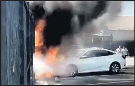  ?? Tausif Khan ?? FLAMES FROM a burning tent spread to two cars at 38th and Hill streets in March. Afterward, more homeless people set up camp on the sidewalk nearby.