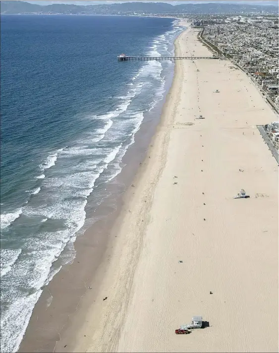  ??  ?? CLOSED BEACHES and parks were the norm for parts of the year in Southern California, including this vast deserted stretch as seen from Hermosa Beach in March.