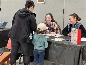  ?? PHOTO BY REBECCA WASIK —THE REPORTER ?? Leidy Madera and her son explore the youth sports booth at the 2023Parks and Recreation Expo in Vacaville.