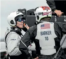  ??  ?? Skipper Terry Hutchinson talks with Kiwi helmsman Dean Barker on board American Magic.