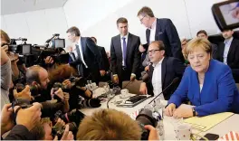  ?? — AP ?? German Chancellor Angela Merkel, chairwoman of the Christian Democratic Union, CDU, sits next to party colleague Alexander Dobrindt prior to a faction meeting at the Reichstag building in Berlin on Monday.