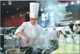  ?? PHOTOS BY LIANG XU / XINHUA ?? Chefs compete in a cooking skills challenge at this year’s Asia Pacific selection of Bocuse d’Or, a global gastronomi­c contest, in Guangzhou, Guangdong province, in mid-May.