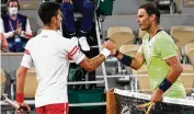  ?? MICHEL EULE / AP 2021 ?? Novak Djokovic (left)and Rafael Nadal could meet in the quarterfin­als at this year’s French Open. Djokovic beat Nadal in the semifinals last year.