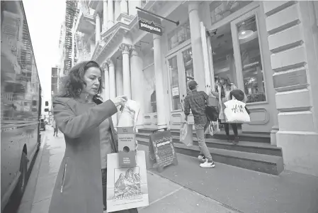  ?? JENNIFER S. ALTMAN FOR USA TODAY ?? Christina Cobb enjoys a day of shopping recently in New York City. When it comes to buying gifts, she says, “I always seek out the least-toxic and most eco-friendly options.”