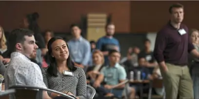  ?? Alexandra Wimley/Post-Gazette ?? Cynthia Rosensteel, an intern for Duquesne Light Company, second from left, smiles as Steelers linebacker Ryan Shazier speaks during the Pittsburgh Passport Summer Internship Series launch event at Heinz Field on Wednesday on the North Shore.