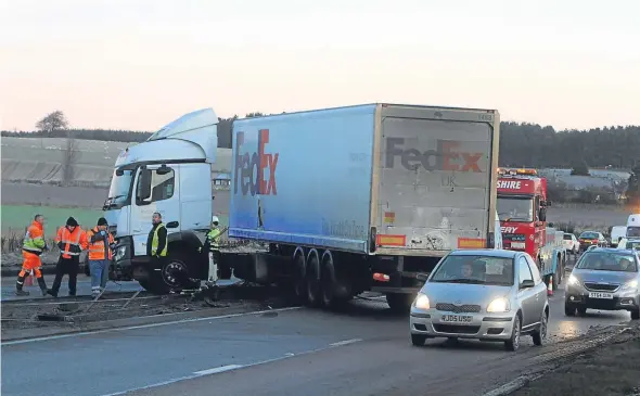  ??  ?? The jack-knifed lorry on the A90 where there were long tailbacks in both directions.