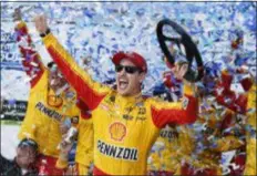  ?? STEVE HELBER - THE ASSOCIATED PRESS ?? Joey Logano celebrates after winning the Monster Energy Cup race at Martinsvil­le Speedway Sunday.