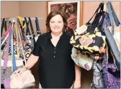  ??  ?? Carolyn Brinkley of Arkadelphi­a displays a variety of her handcrafte­d purses that will be shown during this year’s Caddo River Arts Guild Round About Artists Studio Tour.