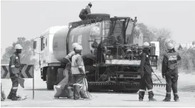  ??  ?? The Bulawayo City Council continues to work on roads damaged by floods ahead of the rain season. In the picture taken yesterday, workmen attend to a road in Kelvin industrial area