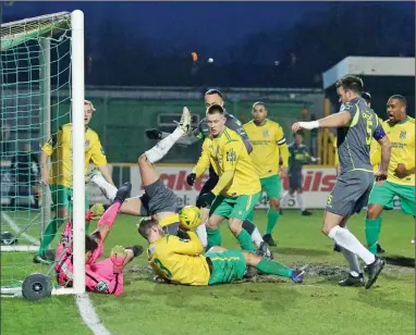  ??  ?? BEN BUNDLE: Comic mayhem ensues as Ben Martin, No.5, forces home Staines’ second goal