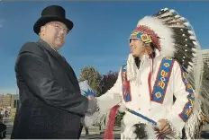  ?? PENDER FILES GREG ?? Don Atchison, left, and Dakota Whitecap First Nation Chief Darcy Bear shake hands to mark the 125th anniversar­y of the meeting of John Lake and Chief Whitecap at the Victoria Bridge roundabout in 2007.