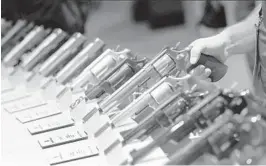  ?? JOHN LOCHER/AP 2016 ?? Handguns are displayed at a trade show in Las Vegas. The gunman accused in last week’s deadly shootings at three Atlanta-area businesses legally purchased a 9 mm handgun hours before the rampage. Georgia does not have a waiting period.