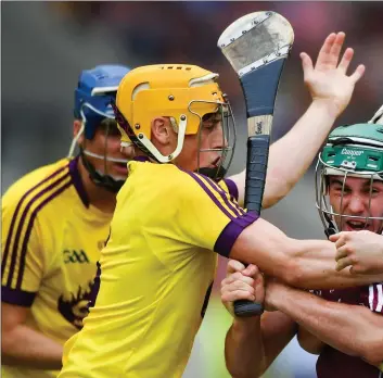  ??  ?? Galway attacker Evan Niland has nowhere to go as Wexford duo Damien Reck and Rory O’Connor close him d