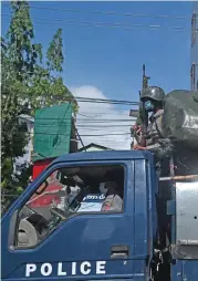  ?? (AFP) ?? Police patrol in a truck in downtown Yangon on Friday