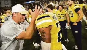  ?? Daniel Varnado / Associated Press ?? Georgia Tech interim head coach Brent Key celebrates with defensive back Clayton Powell-Lee after defeating Duke 23-20 in overtime Saturday at Bobby Dodd Stadium, in Atlanta.