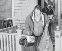  ?? DAVE STEWART • THE GUARDIAN ?? Connor Kelly, tenant organizer with Cooper Institute and P.E.I. Fight for Affordable Housing, helps Lisa Hughes remove her two cats from her apartment on Richmond Street in Charlottet­own after being evicted on short notice Friday.