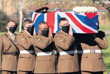  ?? PICTURES: JOE GIDDENS / PA WIRE ?? ■ Members of the Armed Forces stand in formation during a private funeral service for Captain Sir Tom Moore yesterday and, right, Captain Sir Tom’s coffin is carried by members of the Armed Forces