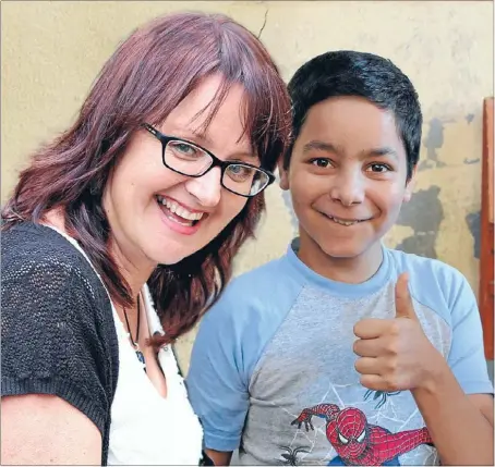  ??  ?? Helping hand: Orphans Aid Internatio­nal chief executive, Sue van Schreven, with Andrei. He was abandoned at birth and rescued from a hospital cot when he was
three in 2004.