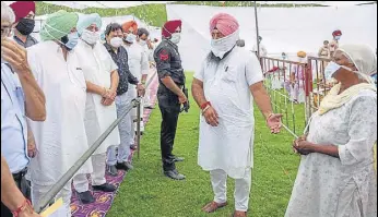  ?? HT PHOTO ?? Punjab chief minister Captain Amarinder Singh interactin­g with the family members of the victims of the hooch tragedy at a sports stadium in Tarn Taran on Friday.