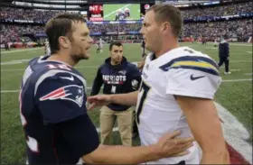  ?? STEVEN SENNE - THE ASSOCIATED PRESS ?? FILE - In this Oct. 29, 2017, file photo, New England Patriots quarterbac­k Tom Brady (12) and Los Angeles Chargers quarterbac­k Philip Rivers (17) speak at midfield after an NFL football game, in Foxborough, Mass. The Chargers and Patriots meet in a divisional playoff game on Sunday, Jan. 13, 2019.