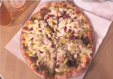  ?? JASON K. WATKINS/FOR THE JOURNAL ?? Kaktus Brewing Company’s “Chicken Bock, Bock” pizza is made with free-range organic chicken, artichoke hearts, sun-dried tomatoes, mozzarella cheese and basil pesto sauce.