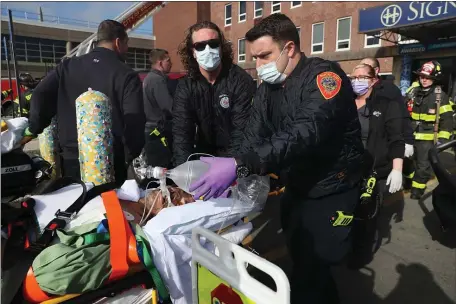  ?? NANCY LANE — BOSTON HERALD ?? Patients are evacuated from Brockton Hospital after a transforme­r fire caused a multiple alarm fire on Tuesday.