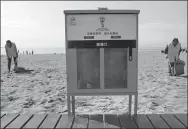  ?? CAO JIANXIONG / FOR CHINA DAILY ?? A cigarette butt collection bin at Qinhuangda­o’s Dream Bay in Hebei province. People can vote for their favorite World Cup team by throwing their butts in a designated bin.