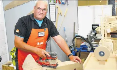  ??  ?? Colin Petterson at work in B&Q – his creations from offcuts are being sold for charity