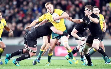  ?? — Reuters photo ?? Australia’s Dane Haylett-Petty (centre) is tackled during the Bledisloe Cup Rugby Championsh­ip against New Zealand at Eden Park in Auckland, New Zealand in this Aug 25 file photo.