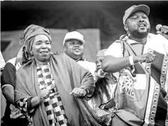  ??  ?? Dlamini (left) dances on stage with supporters at her final campaign at a African National Congress (ANC) Kwazulu-Natal rally in Clermont township south of Durban. — AFP photo