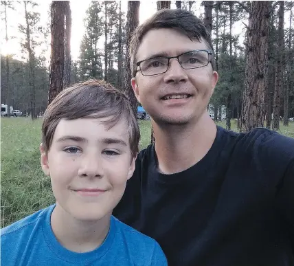  ?? — ERIC SHELKIE ?? Web programmer Eric Shelkie poses with his 13-year-old son Evan while camping near Osoyoos. Shelkie, a partner in the design firm SmashLAB, developed a program capable of finding campsites due to cancellati­ons on B.C. Parks’ Discover Camping website....
