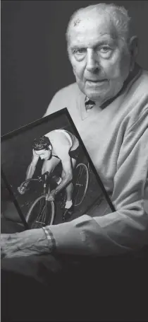  ?? AFP ?? Charles Coste, Olympic cycling champion in the men's team pursuit at the 1948 London Games, at his home in northwest Paris on Jan 30, poses with a photo of himself competing.