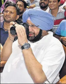  ?? PTI ?? Chief minister Capt Amarinder Singh clicks a picture at an exhibition organised by the Photojourn­alists Welfare Associatio­n on the eve of the World Photograph­y Day in Chandigarh on Friday.