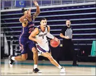  ?? Douglas P. DeFelice / Getty Images ?? Gonzaga’s Jalen Suggs dribbles past Auburn’s Allen Flanigan Friday during the second half of their Rocket Mortgage Fort Myers Tip-Off game at Suncoast Credit Union Arena in Fort Myers, Fla.