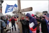  ??  ?? Praying for insurrecti­on at the Capitol